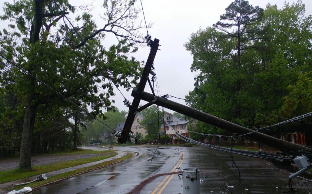 A power pole lies on its side after a storm.